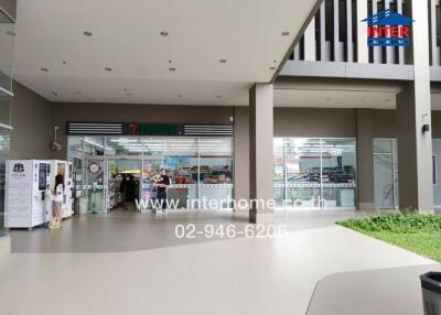 Entrance of a modern building with a convenience store