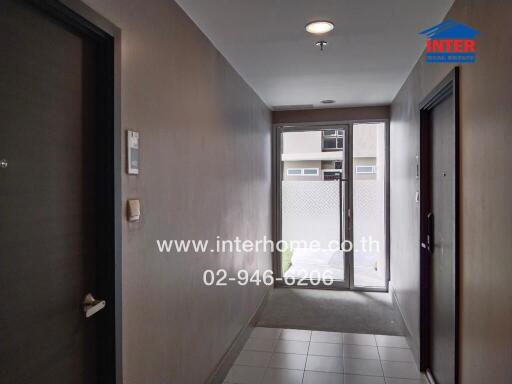 Apartment hallway with doors and a window