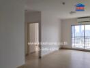 Spacious living room with natural light and balcony access