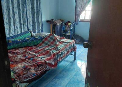 Bedroom with bed, curtains, and tiled floor