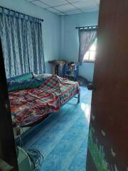 Bedroom with bed, curtains, and tiled floor