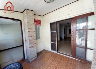 Main entrance with large glass door and tiled floor