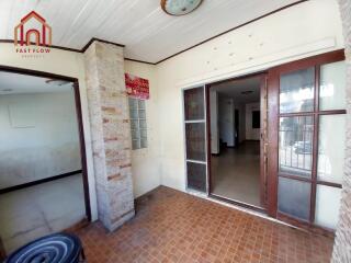 Main entrance with large glass door and tiled floor