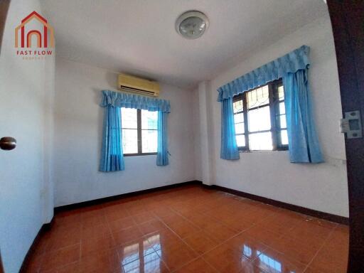 Bedroom with blue curtains and air conditioner