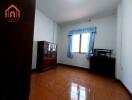 Bedroom with wooden furniture and large window