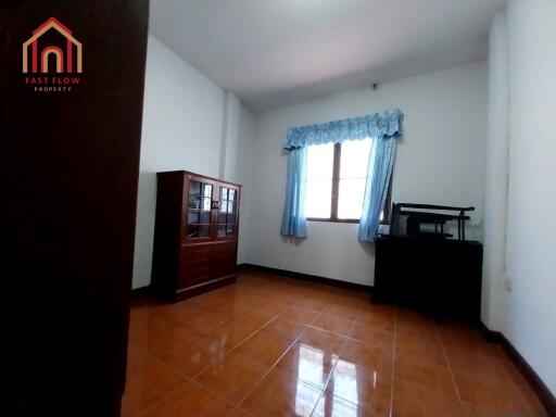 Bedroom with wooden furniture and large window