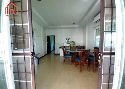 Spacious dining area with wooden furniture and air conditioning