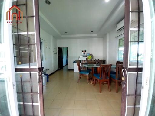 Spacious dining area with wooden furniture and air conditioning