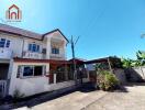 Two-story house with driveway and carport