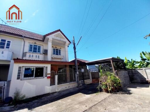 Two-story house with driveway and carport