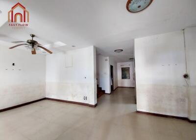 Spacious main living area with ceiling fan and tile flooring