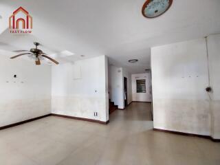 Spacious main living area with ceiling fan and tile flooring