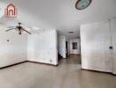 Spacious main living area with ceiling fan and tile flooring