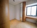 Bright bedroom with wooden details and large window