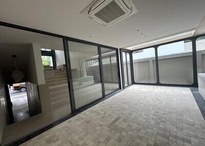 Spacious room with large windows and tiled floor