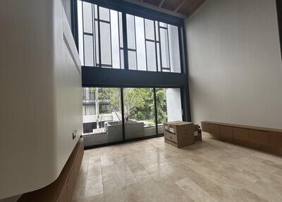 Modern living room with large windows and high ceiling