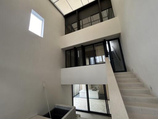 Interior view of a modern building with large windows and staircase