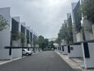 Modern row of townhouses with cars parked in front