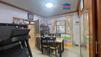 Cozy room with fitness equipment and dining area