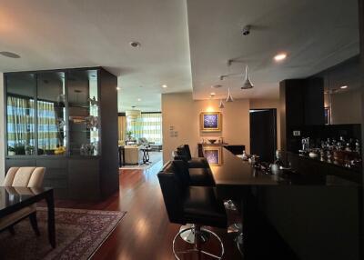 Modern kitchen with bar seating and adjacent dining area