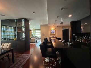 Modern kitchen with bar seating and adjacent dining area