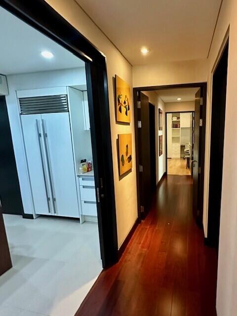 Modern hallway with view of kitchen and living area