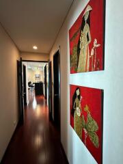 Hallway with wooden floor and colorful paintings