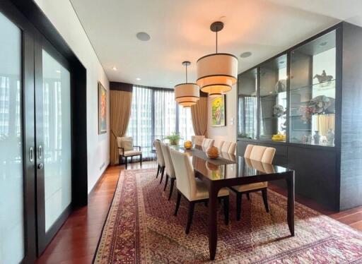 Elegant dining room with glass doors and modern lighting