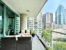 Spacious balcony with outdoor furniture and cityscape view