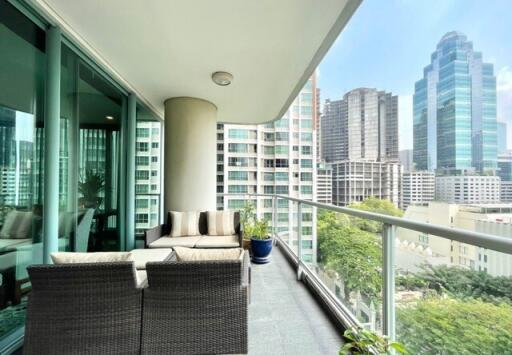 Spacious balcony with outdoor furniture and cityscape view