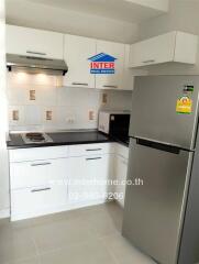 Modern kitchen with stainless steel appliances and white cabinetry