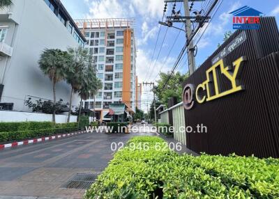 Exterior view of apartment building with sign and contact information