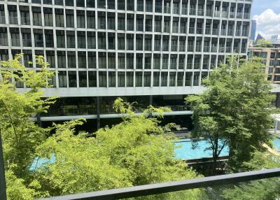 View of swimming pool and building from balcony