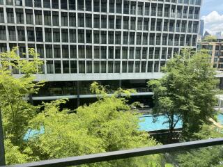 View of swimming pool and building from balcony