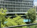 View of swimming pool and building from balcony