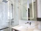 Modern bathroom with a glass shower enclosure and a stylish vanity