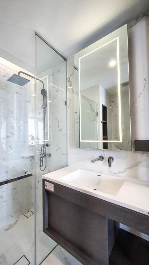 Modern bathroom with a glass shower enclosure and a stylish vanity