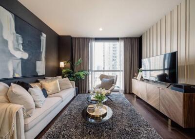 Modern living room with large TV, couch, coffee table, and a window view