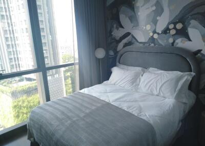 Modern bedroom with large windows and city view