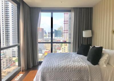 Modern bedroom with large windows and city view