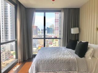 Modern bedroom with large windows and city view