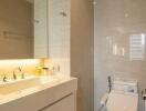 Modern bathroom with sink, mirror, and toilet