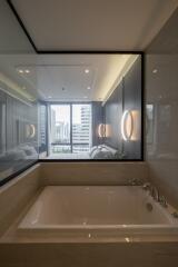 Modern bathroom with a large bathtub and a view of the city