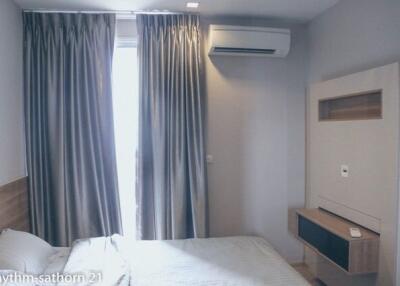 Bedroom with bed, curtains, and air conditioner