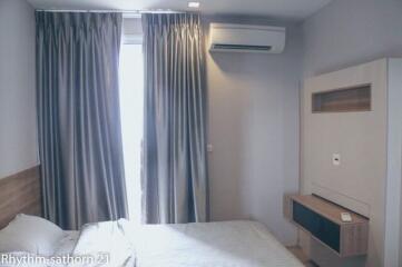 Bedroom with bed, curtains, and air conditioner