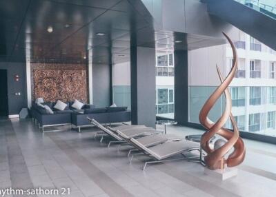 Modern apartment building communal area with seating and sculptures