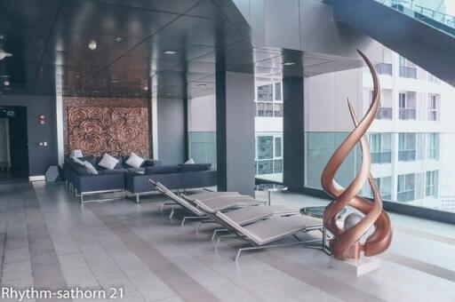 Modern apartment building communal area with seating and sculptures