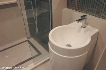 Modern bathroom with glass shower and stylish sink