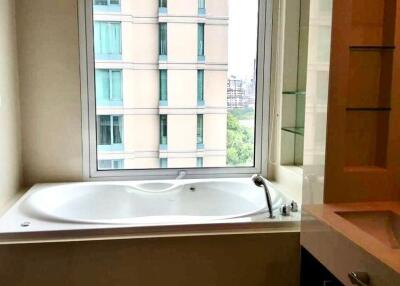 Bathroom with tub and window