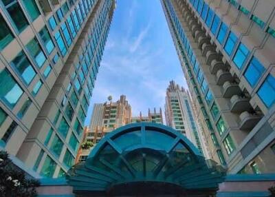 Tall modern skyscrapers with blue windows and central entrance